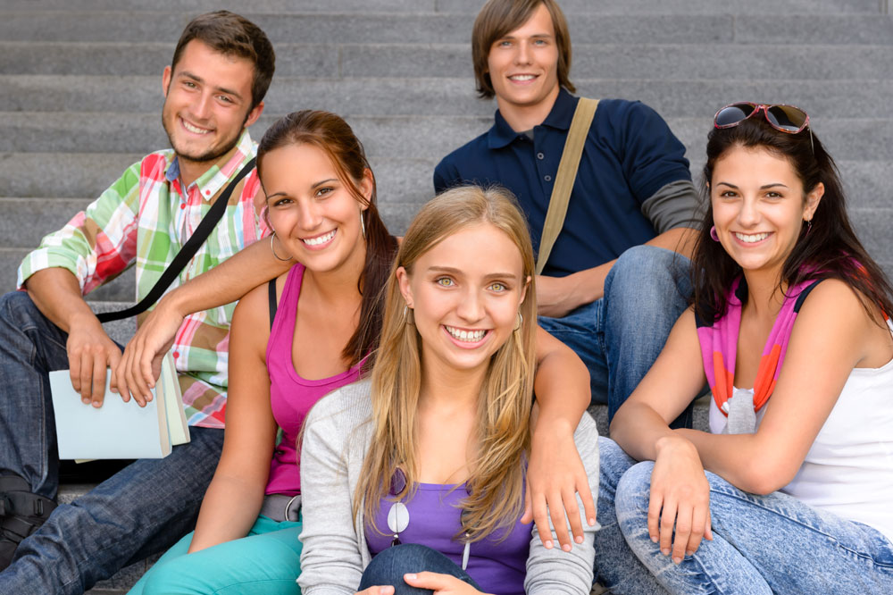 A group of young people sitting on steps.