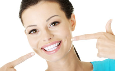 A woman showing her teeth to the camera.