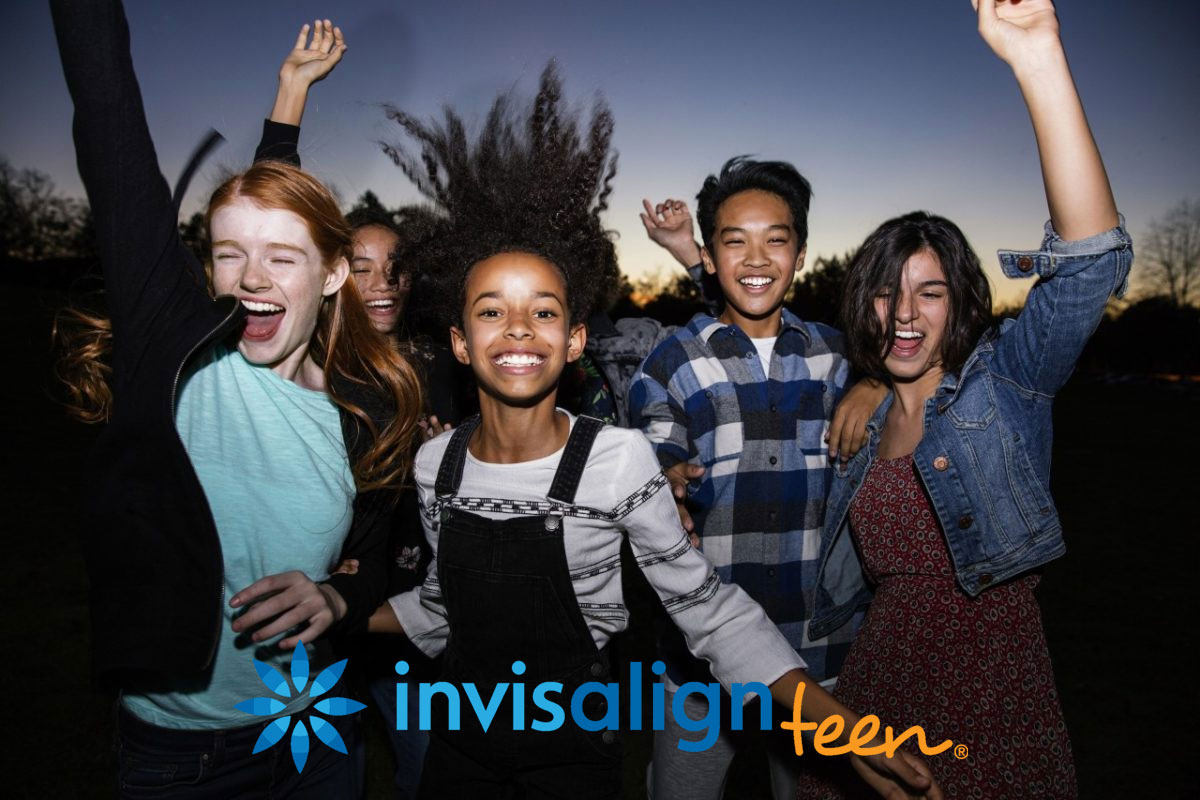 group of 5 teens happy jumping showing their invisalign braces for teens